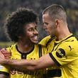 Dortmund's Karim Adeyemi, left, celebrates with Waldemar Anton, after scoring his side's third goal during the Champions League opening phase soccer match between Borussia Dortmund and Celtic FC in Dortmund, Germany, Tuesday, Oct. 1, 2024. (Bernd Thissen/dpa via AP)