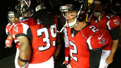 Falcons' Matt Ryan has the look of intensity as he enters the tunnel to take the field with Steven Jackson and his teammates to play the Saints in their NFL football game on Sunday, Sept. 7, 2014, in Atlanta.