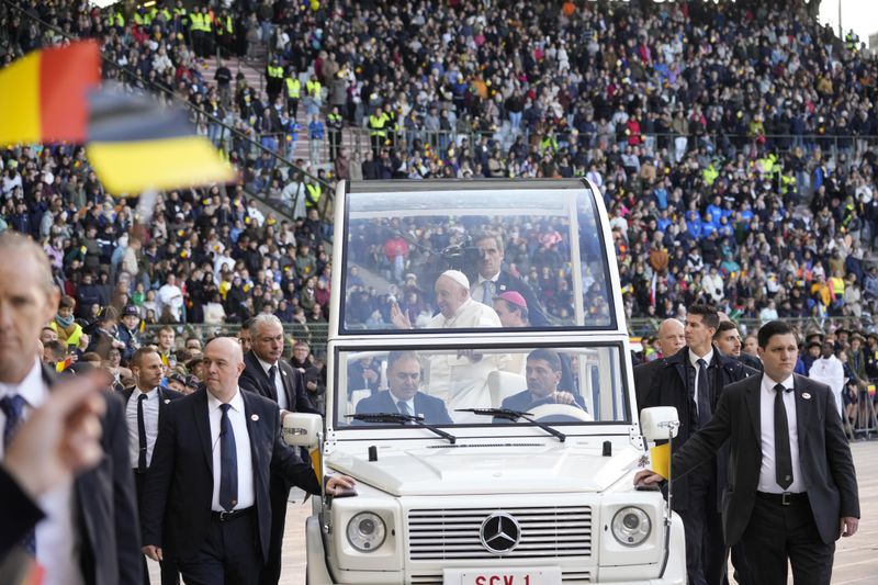 Pope Francis is cheered by faithful as he arrives to preside over the Sunday mass in King Baudouin Stadium, in Brussels Sunday, Sept. 29, 2024. (AP Photo/Andrew Medichini)