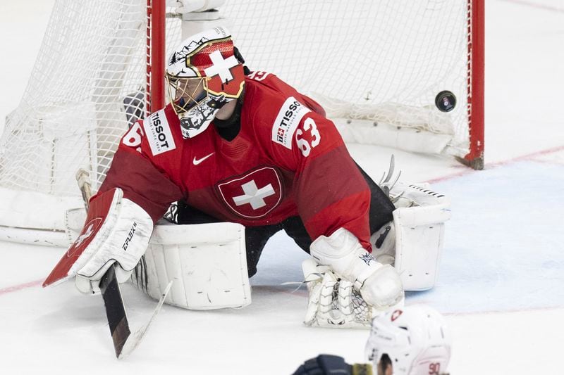 Switzerland goalkeeper Leonardo Genoni reacts after the first goal during the Ice Hockey World Championship final match against the Czech Republic in Prague, Czech Republic, at the O2 Arena, Sunday, May 26, 2024. (Peter Schneider/Keystone via AP)