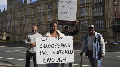 Chagossians Whitney Tranquille, center, attends a protest to response the U.K. announcement to agree to hand sovereignty of the long-contested Chagos Islands to Mauritius and against their "Exclusion" from Chagos negotiations, outside the House of Parliament, in London, Monday, Oct. 7, 2024. (AP Photo/Kin Cheung)