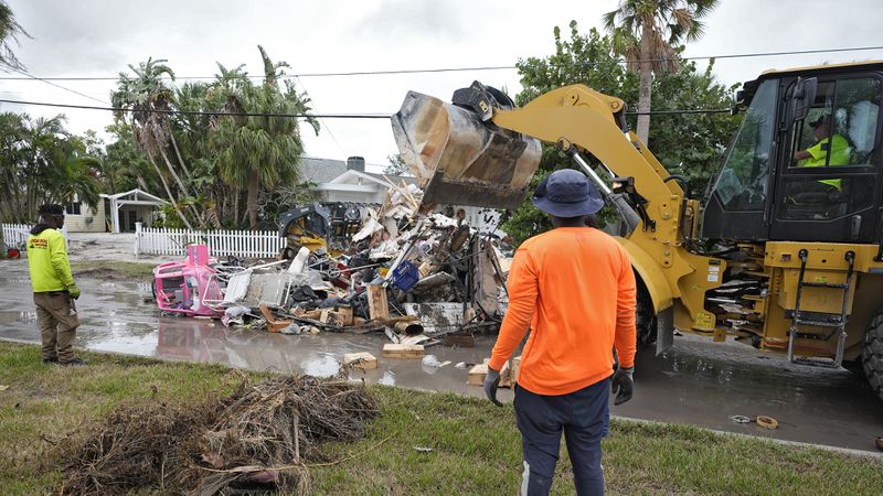 Salvage works remove debris from Hurricane Helene flooding along the Gulf of Mexico Monday, Oct. 7, 2024, in Clearwater Beach, Fla. Crews are working to remove the debris before Hurricane Milton approaches Florida's west coast. (AP Photo/Chris O'Meara)