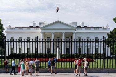 Visitors stand outside the White House, Tuesday, July 23, 2024, in Washington. (AP Photo/Julia Nikhinson)