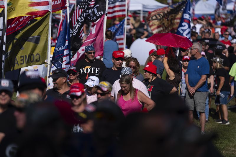 People wait in line to attend a town hall with Republican presidential candidate former President Donald Trump at the Dort Financial Center, Tuesday, Sept. 17, 2024, in Flint, Mich. (AP Photo/Evan Vucci)