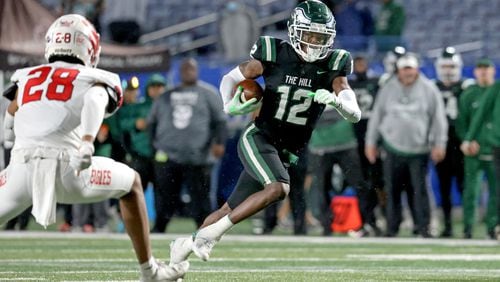 December 11, 2021 - Atlanta, Ga: Collins Hill wide receiver Travis Hunter (12) runs after a catch against Milton during the first half of the Class 7A state title football game at Georgia State Center Parc Stadium Saturday, December 11, 2021, Atlanta. JASON GETZ FOR THE ATLANTA JOURNAL-CONSTITUTION



