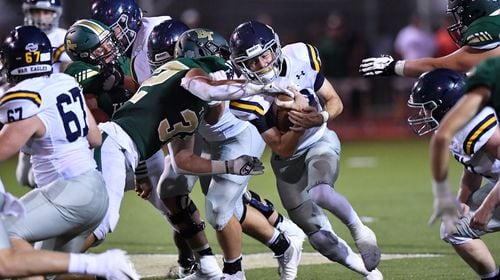 Marist's Champ Davis (10) gets tackled by Blessed Trinity's Mavrick Torrico (32) in the second half at Blessed Trinity Catholic High School in Roswell on Friday, August 27, 2021. Marist won 28-13 over Blessed Trinity. (Hyosub Shin / Hyosub.Shin@ajc.com)