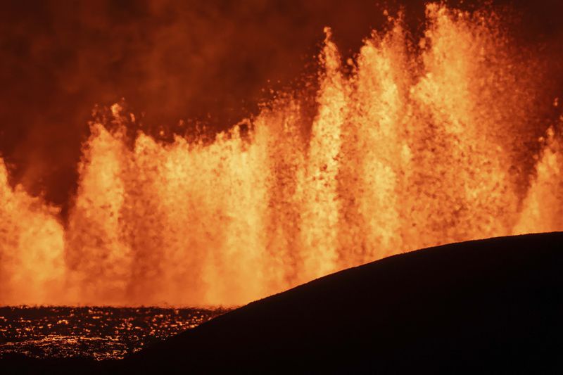 View of the lava fountains pouring out from the new eruptive fissure opened at Svartsengi volcanic system, Iceland, Thursday, Aug. 22, 2024, in a similar location as the previous eruptions. The fissure is 3 km north of Grindavik. (AP Photo/Marco di Marco)