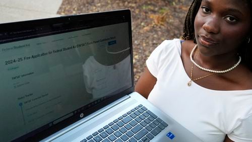 Adjovi Golo holds a laptop at DePaul University in Chicago, Wednesday, Aug. 28, 2024. (AP Photo/Nam Y. Huh)