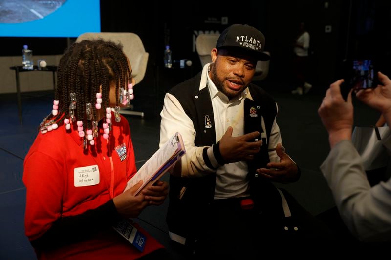 (Left to right) Scholastic junior journalist Sky Oduaran interviews Atlanta Influences Everything cofounder Bem Joiner during The AJC’s Unapologetically Black live event at The Gathering Spot on Wednesday, March 22, 2023.  (Natrice Miller/ natrice.miller@ajc.com)