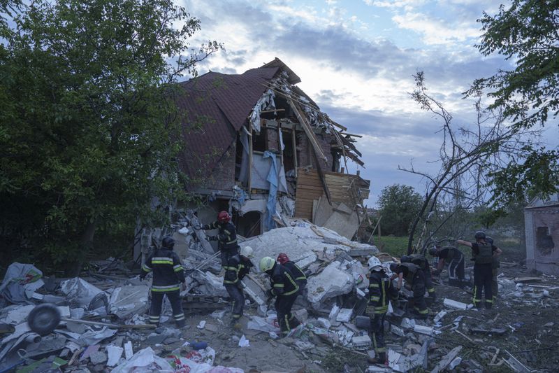 Rescue workers clear the rubble of a building which was destroyed by a Russian airstrike in Kharkiv, Ukraine, Monday, June 10, 2024. (AP Photo/Evgeniy Maloletka)