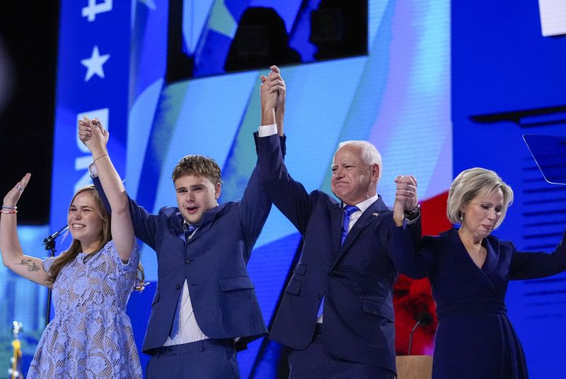 Democratic vice presidential nominee Minnesota Gov. Tim Walz celebrates with his family during the Democratic National Convention Wednesday, Aug. 21, 2024, in Chicago. (AP Photo/Brynn Anderson)