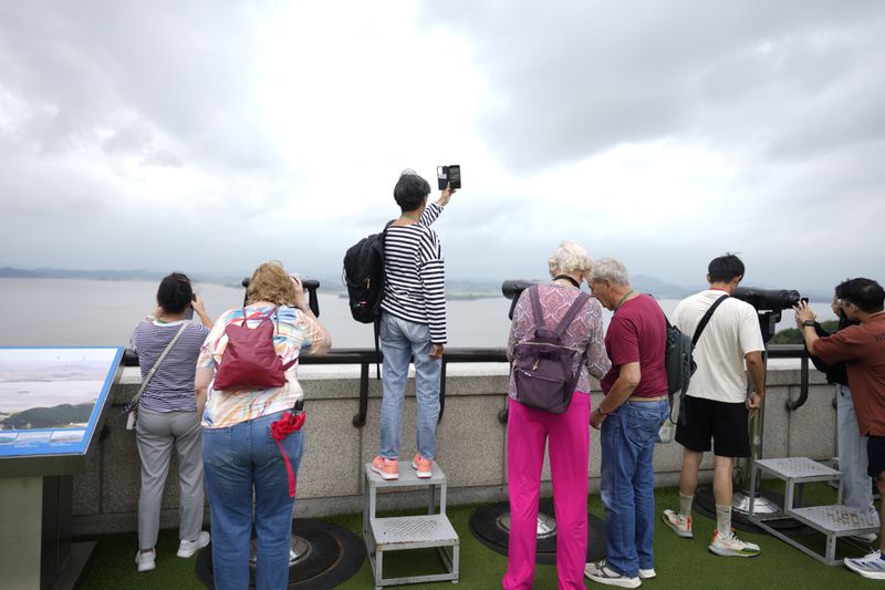 Visitors look at the North Korean side from the unification observatory in Paju, South Korea, Thursday, Sept. 5, 2024. (AP Photo/Lee Jin-man)