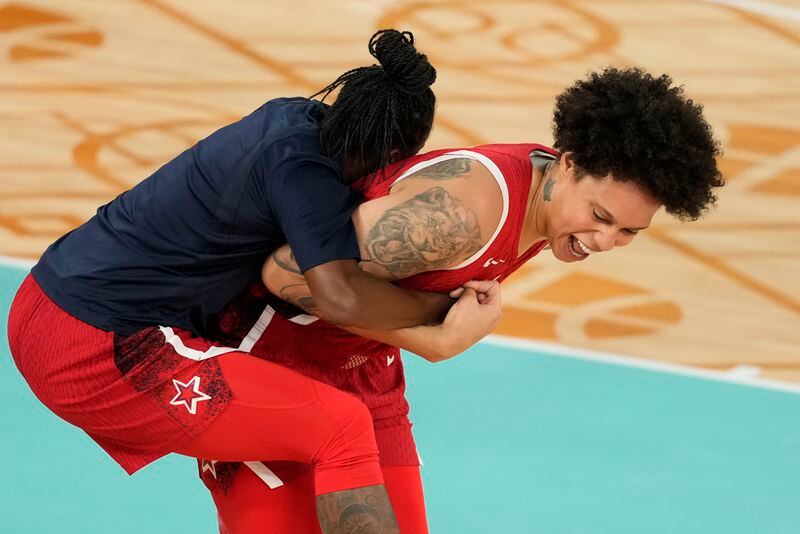 United States' Brittney Griner (15) and United States' Chelsea Gray (8) celebrate after a women's gold medal basketball game at Bercy Arena at the 2024 Summer Olympics, Sunday, Aug. 11, 2024, in Paris, France. (AP Photo/Michael Conroy)