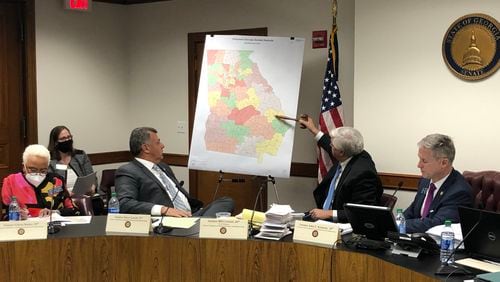 State Sen. Bill Cowsert, a Republican from Athens, points to new Senate districts during a committee meeting Thursday. From left: Sens. Gloria Butler, D-Stone Mountain; Steve Gooch, R-Dahlonega; Cowsert; and Redistricting Chairman John Kennedy, R-Macon. MARK NIESSE / MARK.NIESSE@AJC.COM