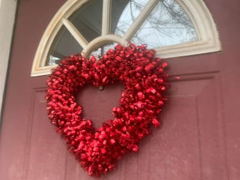 People across metro Atlanta have been hanging hearts and  encouraging messages on windows, even as we all practice social distancing. (Contributed)