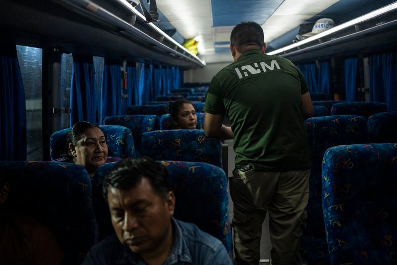 A National Migration Institute agent checks the documents of bus passengers at an immigration checkpoint in Nuevo Teapa, southern Mexico, Saturday, June 8, 2024. Mexico is under pressure from the U.S. to block millions of migrants headed north. (AP Photo/Felix Marquez)