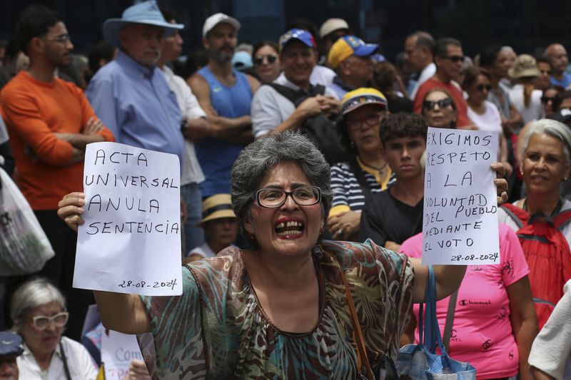 Opposition supporters protest the reelection of President Nicolás Maduro one month after the disputed vote, which opposition leaders claim they won by a landslide, in Caracas, Venezuela, Wednesday, Aug. 28, 2024. (AP Photo/Cristian Hernandez)