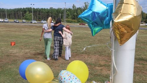 Mourners pay tribute to Apalachee High School shooting victims. (John Spink/AJC)