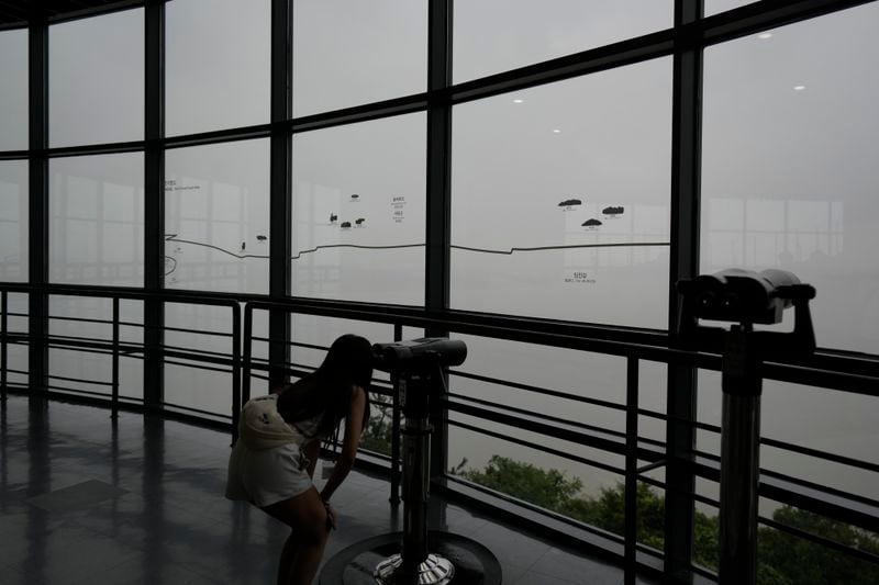 A visitor uses binoculars to see the North Korean side from the unification observatory in Paju, South Korea, Thursday, Sept. 5, 2024. (AP Photo/Lee Jin-man)