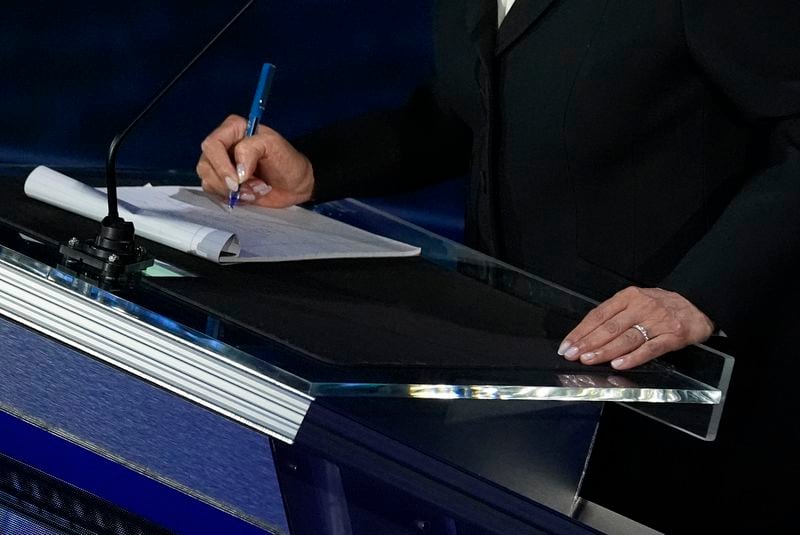 Democratic presidential nominee Vice President Kamala Harris writes notes during a break during a presidential debate with Republican presidential nominee former President Donald Trump at the National Constitution Center, Tuesday, Sept.10, 2024, in Philadelphia. (AP Photo/Alex Brandon)