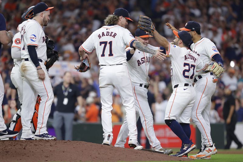 Houston Astros players gather at the mound to celebrate their 4-3 win over the Seattle Mariners to clinch the AL West title at the end of a baseball game Tuesday, Sept. 24, 2024, in Houston. (AP Photo/Michael Wyke)