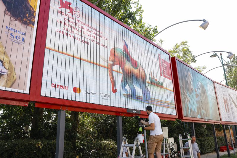 Workers paint signage for the 81st edition of the Venice Film Festival in Venice, Italy, on Tuesday, Aug. 27, 2024. The festival runs from Aug. 27 until Sept. 8. (Photo by Vianney Le Caer/Invision/AP)