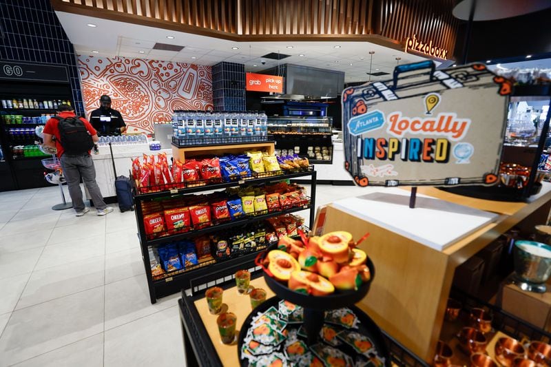 A traveler shops at Southern National Market on Concourse T at Hartsfield-Jackson International Airport. The Market stocks a variety of food from local producers.
(Miguel Martinez / AJC)
