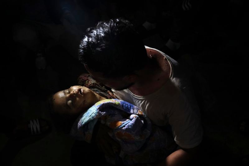 EDS NOTE: GRAPHIC CONTENT - A Palestinian mourns his relative, a child of Rewan Ghanem, killed in an Israeli bombardment on a residential building owned by the Ghanem family in Bureij refugee camp, at al-Aqsa Martyrs hospital in Deir al-Balah, central Gaza Strip, late Monday, June 3, 2024. (AP Photo/Saher Alghorra)