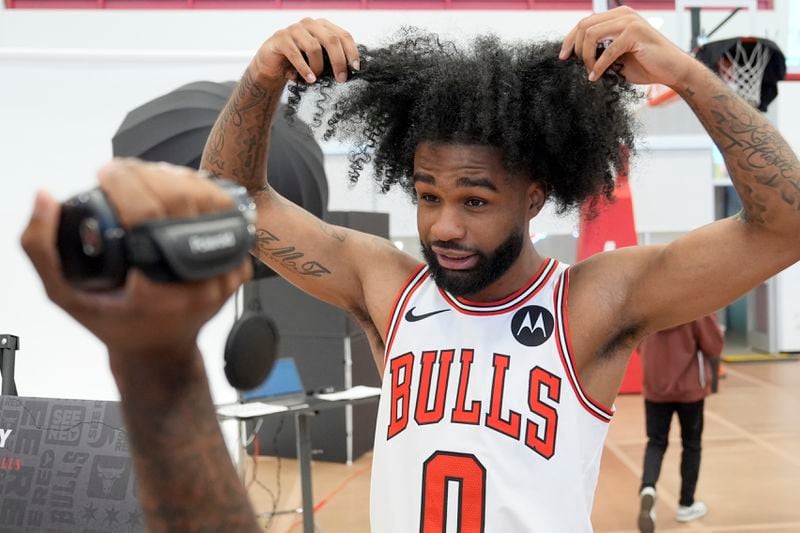 Chicago Bulls guard Coby White talks about his hair for a teammate's video during the NBA basketball team's media day Monday, Sept. 30, 2024, in Chicago. (AP Photo/Charles Rex Arbogast)