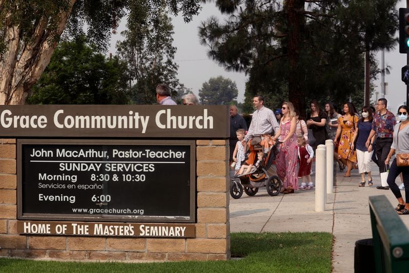 Grace Community Church parishioners make their way to Sunday service in Sun Valley, California, on September 13, 2020. The church held a packed morning service, defying a court order directing them to refrain from holding indoor services due to the COVID-19 pandemic. (Genaro Molina/Los Angeles Times/TNS)