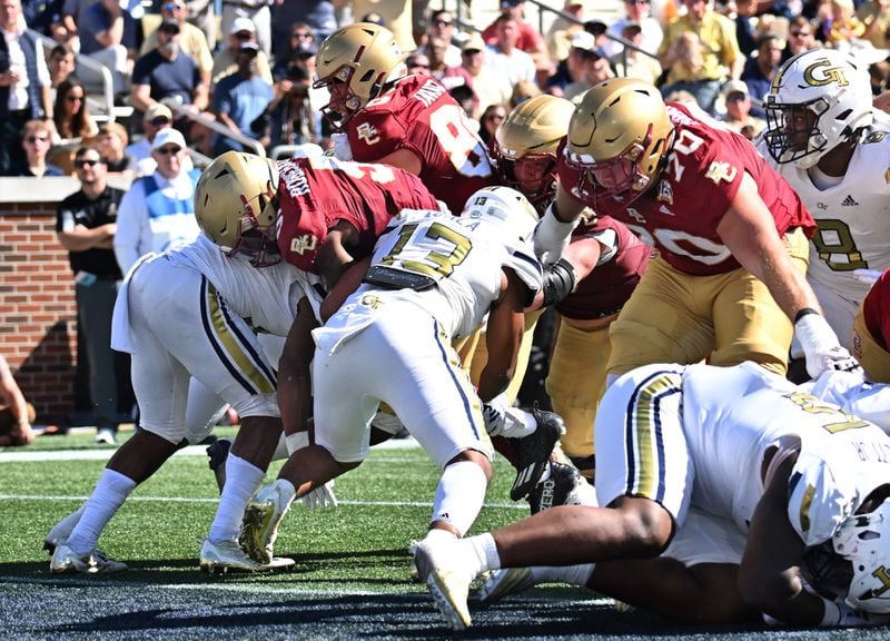 Boston College running back Kye Robichaux (5) pushes against Georgia Tech defensive back Jaylon King (left) and Georgia Tech linebacker Paul Moala (13) for a touchdown during the second half of an NCAA college football game at Georgia Tech's Bobby Dodd Stadium, Saturday, October 21, 2023, in Atlanta. Boston College won 38-23 over Georgia Tech. (Hyosub Shin / Hyosub.Shin@ajc.com)