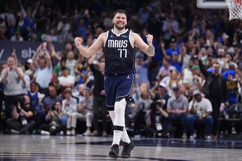 Dallas Mavericks guard Luka Doncic (77) reacts after a play during the first half in Game 4 of the NBA basketball finals against the Boston Celtics, Friday, June 14, 2024, in Dallas. (AP Photo/Julio Cortez)