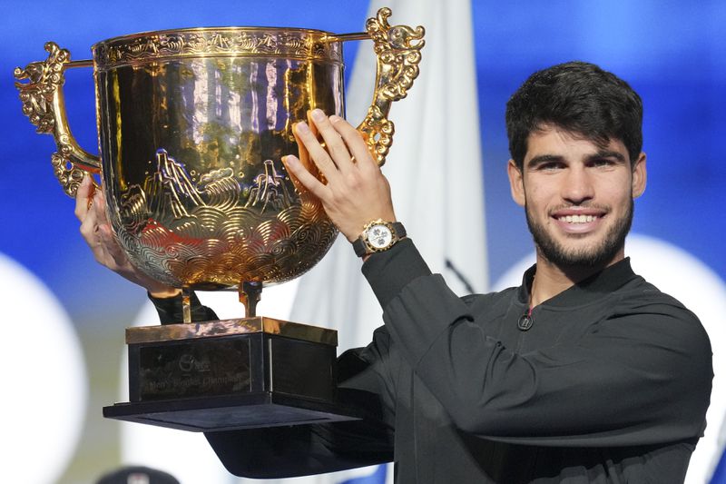 Carlos Alcaraz of Spain poses with his trophy after winning against Jannik Sinner of Italy during their men's singles finals match of the China Open tennis tournament, at the National Tennis Center in Beijing, Wednesday, Oct. 2, 2024. (AP Photo/Achmad Ibrahim)