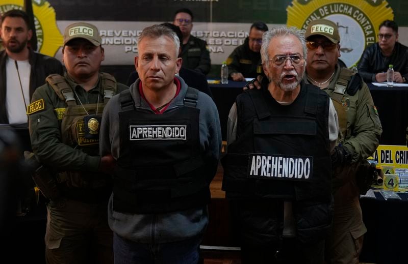 Gen. Juan Mario Paulsen Sandi, left, and Anibal Aguilar Gomez, arrested for his alleged involvement in what President Luis Arce called a coup attempt, is presented to the press in La Paz, Bolivia, Thursday, June 27, 2024. Senior Cabinet member Eduardo del Castillo identified Aguilar Gomez, a civilian, as a key “ideologue” in what Bolivian authorities said was a failed coup attempt. (AP Photo/Juan Karita)