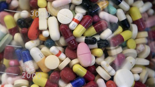 FILE - Prescription drugs are seen in a glass flask at a state laboratory in Taylorsville, Utah, on July 6, 2017. (AP Photo/Rick Bowmer, File)