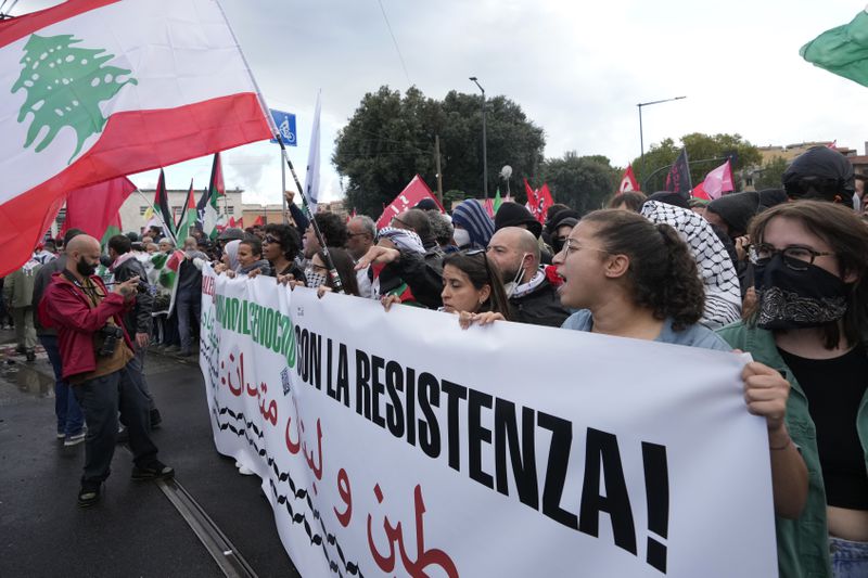 People attend at a protest in Rome, Saturday, Oct. 5, 2024. Pro-palestinians people take to the street in an unauthorised march in the centre of Rome two days ahead of the first anniversary of the Oct. 7. (AP Photo/Andrew Medichini)