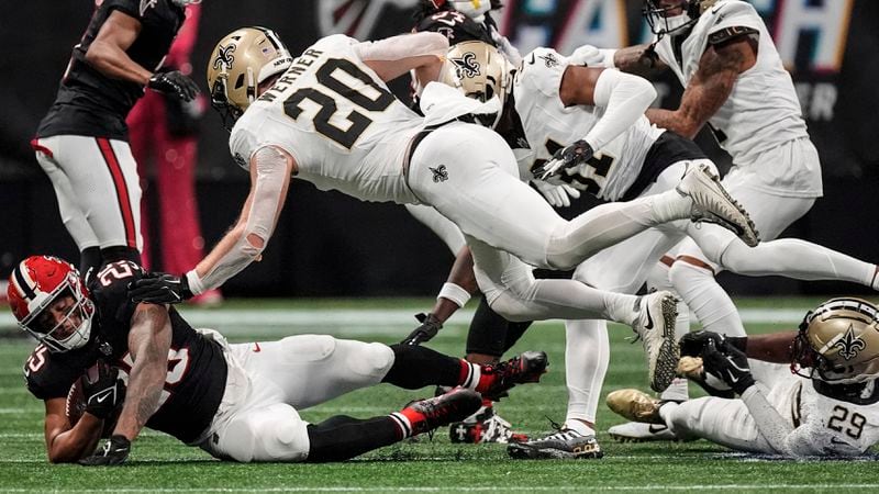 Atlanta Falcons running back Tyler Allgeier (25) runs against New Orleans Saints linebacker Pete Werner (20) during the second half of an NFL football game, Sunday, Sept. 29, 2024, in Atlanta. (AP Photo/John Bazemore)