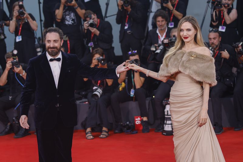 Director Pablo Larrain, left, and Angelina Jolie pose for photographers upon arrival for the premiere of the film 'Maria' during the 81st edition of the Venice Film Festival in Venice, Italy, on Thursday, Aug. 29, 2024. (Photo by Vianney Le Caer/Invision/AP)