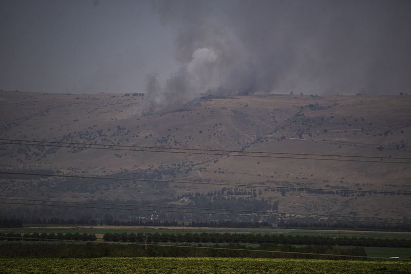 FILE - Smoke rises to the sky as a fire burns an area after a Lebanese shelling, in the Israeli-controlled Golan Heights, Thursday, June 13, 2024. (AP Photo/Leo Correa, File)