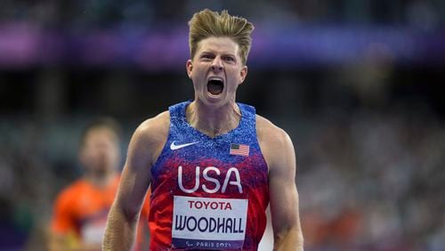 Hunter Woodhall from the U.S. celebrates after winning the men's 400 m. T62 final at the 2024 Paralympics, Friday, Sept. 6, 2024, in Paris, France. (AP Photo/Thibault Camus)