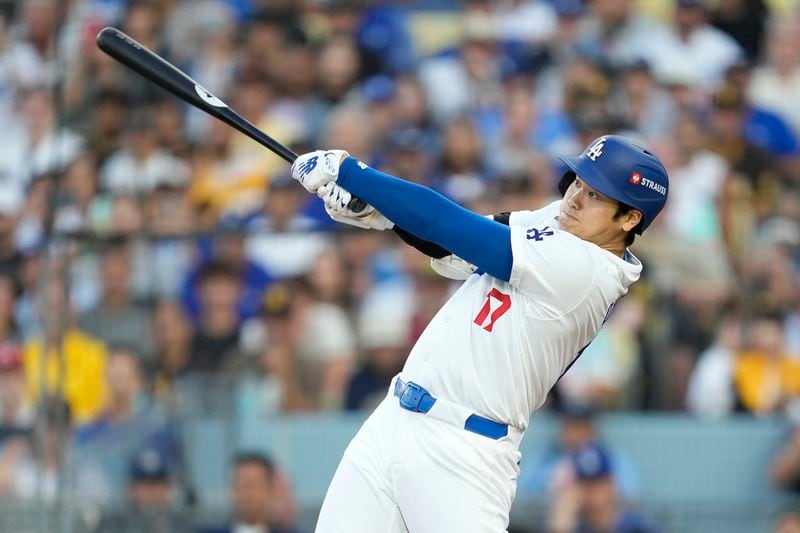 Los Angeles Dodgers' Shohei Ohtani flies out against the San Diego Padres during the first inning in Game 1 of baseball's NL Division Series Saturday, Oct. 5, 2024, in Los Angeles. (AP Photo/Ashley Landis)