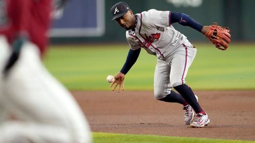 Atlanta Braves' Ozzie Albies bobbles the ball on a base hit by Arizona Diamondbacks' Randal Grichuk during the first inning of a baseball game, Thursday, July 11, 2024, in Phoenix. (AP Photo/Matt York)