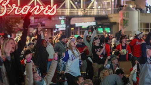 Fans cheer during a watch party at The Battery at Truist Park after Braves player Jorge Soler hits a home run in the first inning of the first game of the World Series between the Braves and Astros being held Tuesday, Oct. 26, 2021, in Houston. (Photo: Branden Camp for The Atlanta Journal-Constitution)