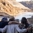 FILE - The Hillman family, from left, Leaf, Lisa, and Chaas, hug as construction crews removed the final cofferdam that was left of Iron Gate Dam allowing the Klamath River to run freely near Hornbrook, Calif., Aug. 28, 2024. (Carlos Avila Gonzalez/San Francisco Chronicle via AP, File)