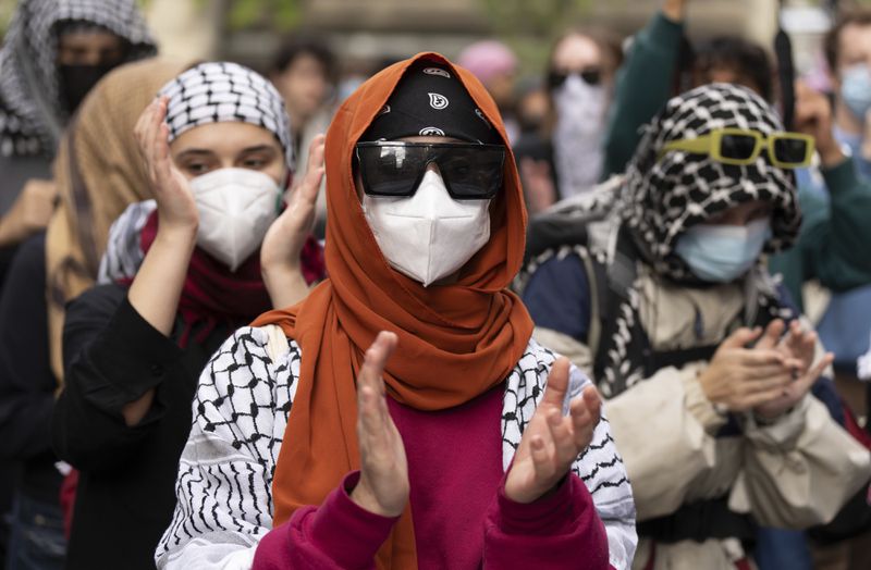 Attendees march during a pro-Palestinian demonstration on the anniversary of a Hamas attack on Israel that triggered the ongoing war in Gaza, in Montreal, Canada, Monday, Oct. 7, 2024. (Christinne Muschi/The Canadian Press via AP)