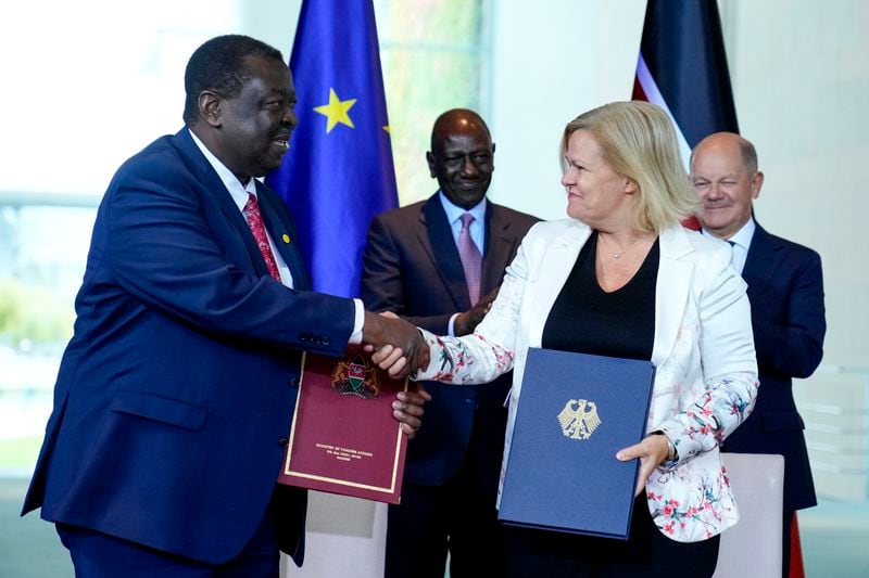 German Interior Minister Nancy Faeser, second from right, and Kenyan's Prime Cabinet Secretary Musalia Mudavadi, left, shake hands after signing a migration agreement at the chancellery in Berlin, Friday, Sept. 13, 2024. Behind them are German Chancellor Olaf Scholz, right, and Kenyan President William Ruto. (AP Photo/Ebrahim Noroozi)