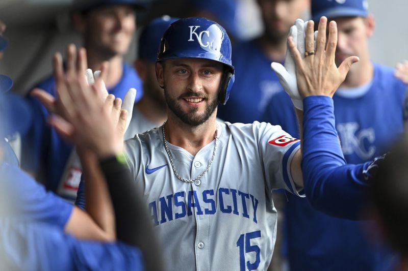 Kansas City Royals' Paul DeJong celebrates with teammates after hitting a solo home run during the second inning of the second game of a baseball doubleheader against the Cleveland Guardians, Monday, August 26, 2024, in Cleveland. (AP Photo/Nick Cammett)