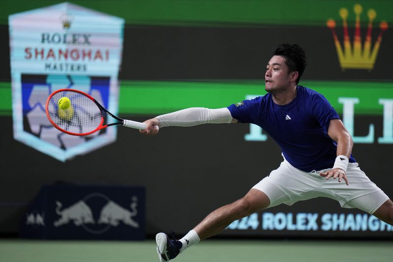 Wu Yibing of China returns a forehand shot to Carlos Alcaraz of Spain during the men's singles third round match of the Shanghai Masters tennis tournament at Qizhong Forest Sports City Tennis Center in Shanghai, China, Sunday, Oct. 6, 2024. (AP Photo/Andy Wong)