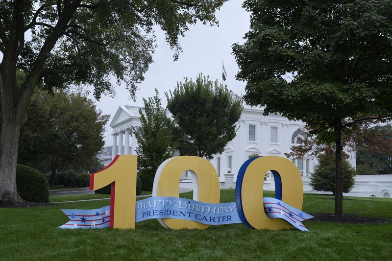 A sign wishing former President Jimmy Carter a happy 100th birthday sits on the North Lawn of the White House in Washington, Tuesday, Oct. 1, 2024. (AP Photo/Susan Walsh)