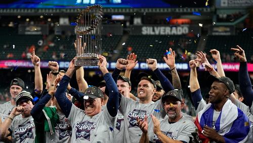 Atlanta Braves manager Brian Snitker holds up the championship trophy after the team won baseball's World Series in Game 6 against the Houston Astros on Nov. 2, 2021, in Houston. (David J. Phillip/AP)